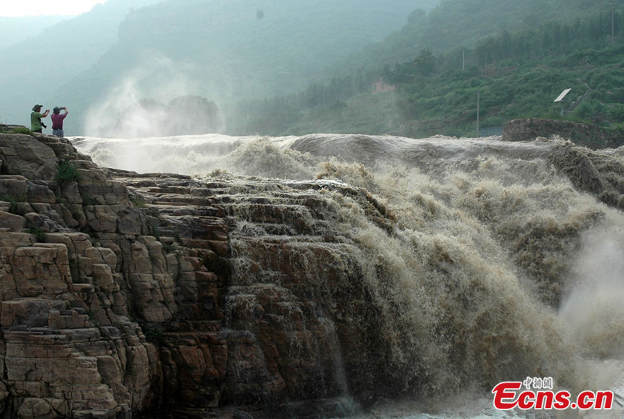 Visitors take photos of waterfalls over Zhang River at Zhang Township of Shexian County in North China's Hebei Province. The Zhang River commences in Shanxi province and flows eastward. It is the border of Hebei and Henan provinces. (CNS/Ma Jiqian)