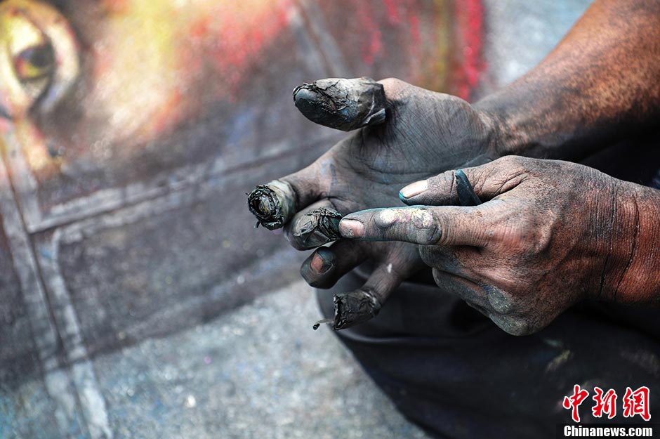 A painter who lost one leg uses chalk and carbon stick to draw “Mona Lisa” and “Avatar” on the street of Kunming, Yunnan province. Cong Guilan's left leg was amputated due to bone tumor when he was 16. Since then with love for arts and determination, he has started to learn drawing; he wishes to enter an art college for professional arts study. (CNS / Liu Ranyang)