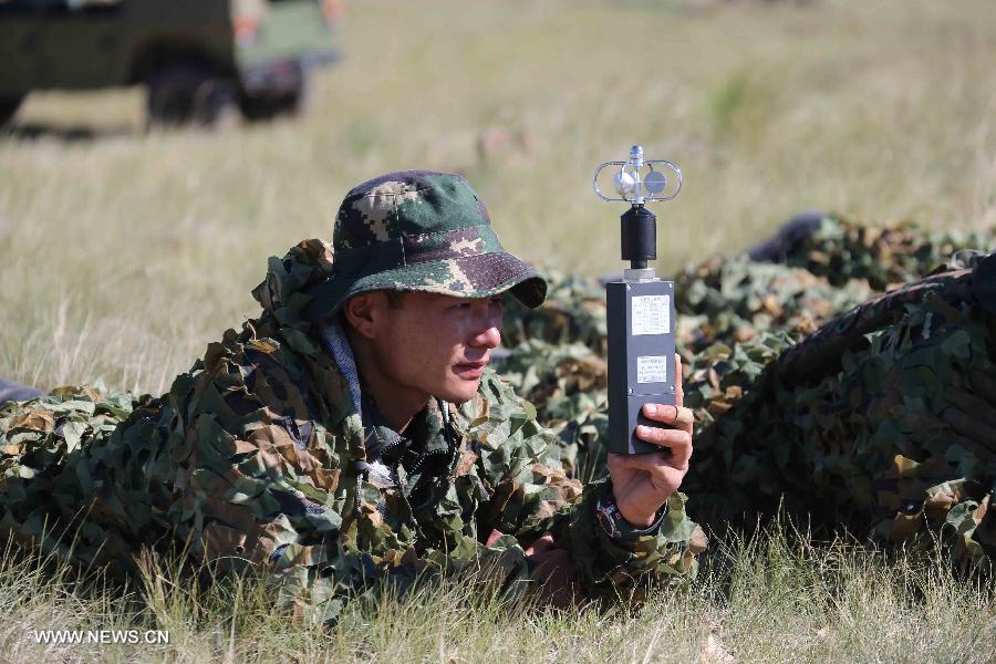 A member of China's People's Liberation Army (PLA) special forces participates in a comprehensive military contest at a PLA training base in north China's Inner Mongolia Autonomous Region, July 23, 2013. (Xinhua/Wang Jianmin)