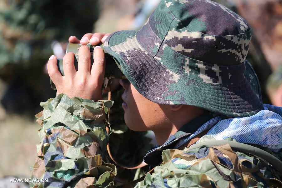 A member of China's People's Liberation Army (PLA) special forces participates in a comprehensive military contest at a PLA training base in north China's Inner Mongolia Autonomous Region, July 23, 2013. (Xinhua/Wang Jianmin)