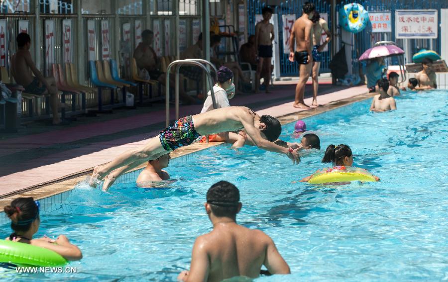 Citizens cool off in a swimming pool in Beijing, capital of China, July 24, 2013. A heat wave hit Beijing on Wednesday, with the highest temperature reaching 36 degrees Celsius. (Xinhua/Zhang Yu) 