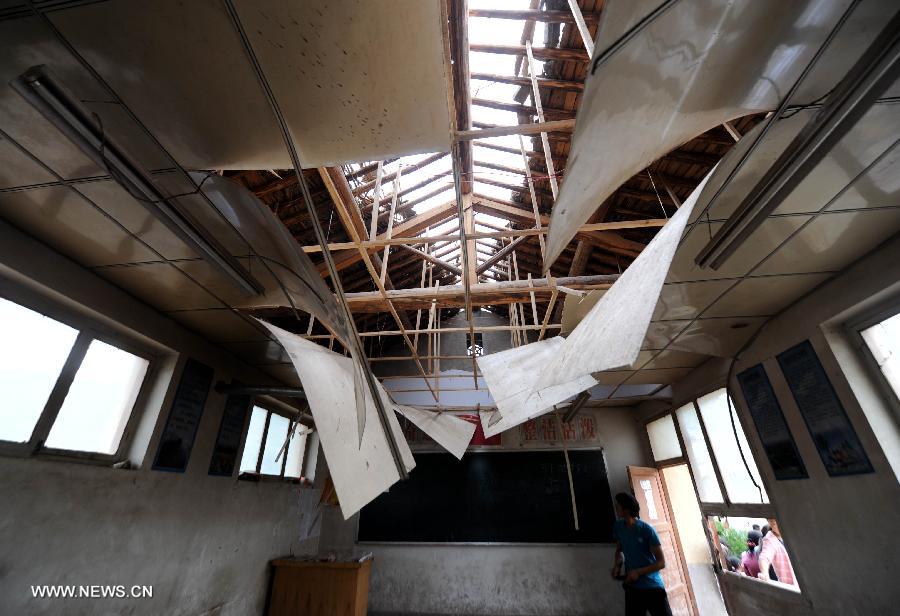 Photo taken on July 24, 2013 shows a damaged classroom of a primary school in the quake-hit Majiagou Village in Meichuan Township, Minxian County, northwest China's Gansu Province. Over 360 schools in Gansu's Minxian and Zhangxian counties were destroyed by the 6.6-magnitude quake that occurred on Monday, affecting 77,000 students, according to the local authorities. (Xinhua/Luo Xiaoguang)