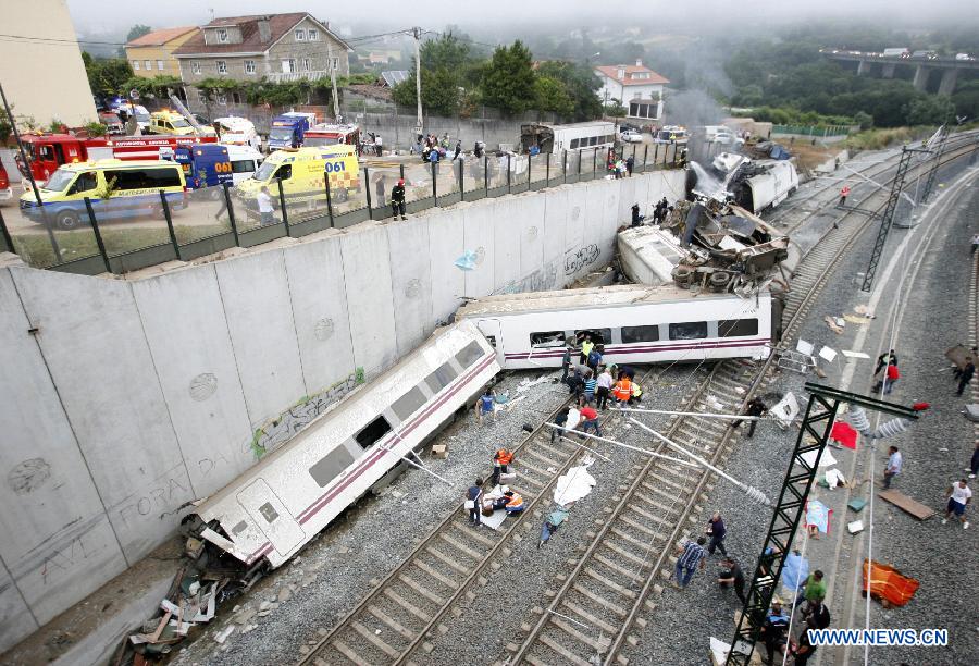 Rescuers and citizens work at the site where a train crashed, at the entrance of Santiago de Compostela Station, in the autonomous community of Galicia, northwest of Spain, on July 24, 2013. Up to 35 people have died and around 100 injured after a train derailed just outside the city of Santiago de Compostela in the region of Galicia in north-western Spain on Wednesday evening. (Xinhua/Oscar Corral)