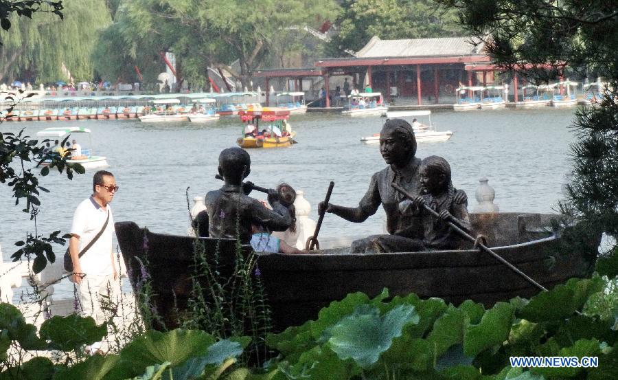 A sculpture named "Let us sway twin oars" is seen at the Beihai Park in Beijing, capital of China, July 25, 2013. The sculpture is in memory of a Chinese popular song of the same name. (Xinhua/Li Xin)