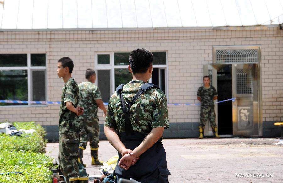 Firefighters are seen at the accident site at the Lianhe Senior Nursing Home where a fire took place in Hailun City, northeast China's Heilongjiang Province, July 26, 2013. Eleven people were killed in the fire that occurred early Friday. Local police said arson has been confirmed as the cause of the fire. A total of 283 elderly people were living in the nursing home, which was built in October 2005. With an area of 7,000 square meters, it caters for the rural elderly in the city who have no source of income. (Xinhua/Wang Song)