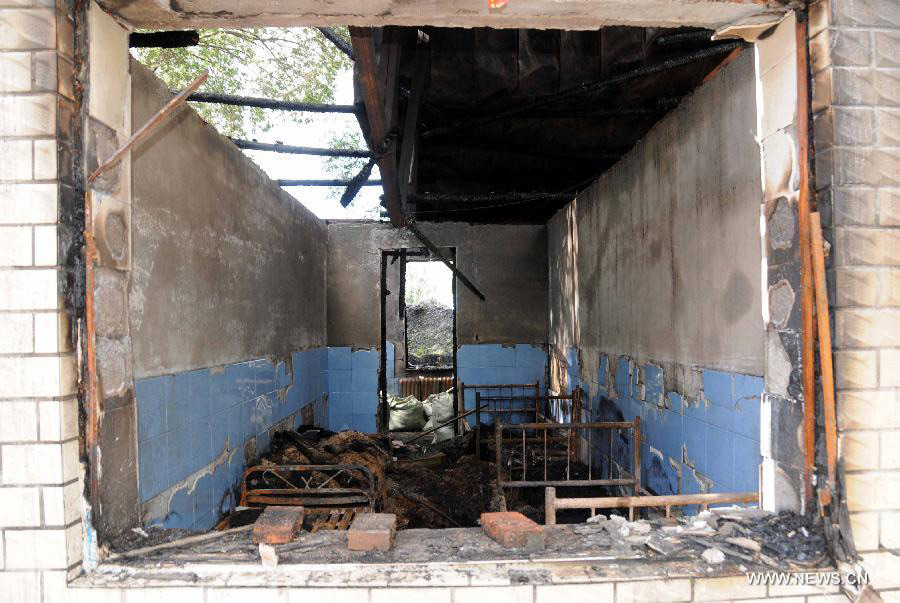 Photo taken on July 26, 2013 shows the accident site at the Lianhe Senior Nursing Home where a fire took place in Hailun City, northeast China's Heilongjiang Province. Eleven people were killed in the fire that occurred early Friday. Local police said arson has been confirmed as the cause of the fire. A total of 283 elderly people were living in the nursing home, which was built in October 2005. With an area of 7,000 square meters, it caters for the rural elderly in the city who have no source of income. (Xinhua/Wang Song)