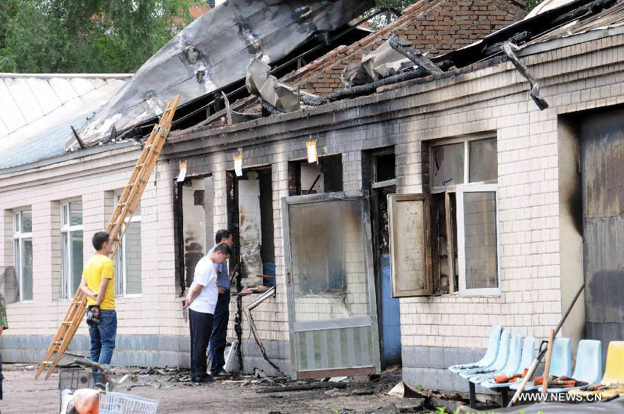 Photo taken on July 26, 2013 shows the accident site at the Lianhe Senior Nursing Home where a fire took place in Hailun City, northeast China's Heilongjiang Province. Eleven people were killed in the fire that occurred early Friday. Local police said arson has been confirmed as the cause of the fire. A total of 283 elderly people were living in the nursing home, which was built in October 2005. With an area of 7,000 square meters, it caters for the rural elderly in the city who have no source of income. (Xinhua/Wang Song)