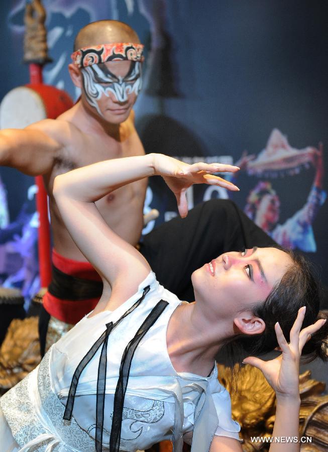 Dancers perform in the press conference of the Dance Drama "Drum God" in Taipei, southeast China's Taiwan, July 26, 2013. The Dance Drama "Drum God" held by two cross-strait ensembles will be performed on Aug. 10 in Taichung City.(Xinhua/Tao Ming)