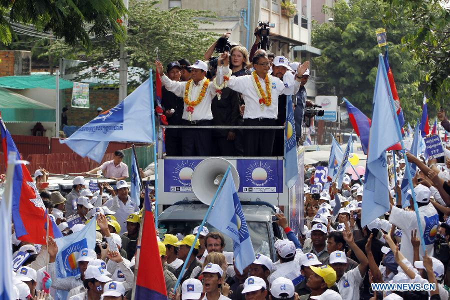 Cambodia's opposition Party -- National Rescue Party leader Sam Rainsy (R, front on a vehicle) attends an election campaign at the Freedom Park in Phnom Penh, Cambodia, July 26, 2013. Cambodia's fifth parliamentary elections are ready to kick off on Sunday, a National Election Committee (NEC) official said Friday. (Xinhua/Sovannara)