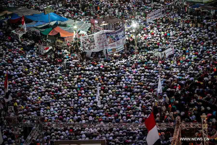 Supporters of Egypt's ousted President Mohamed Morsi pray during a protest in Rabaa Al-Adaweya Square for the 29th day in row, Cairo, July 26, 2013. A top Egyptian court has ordered the detention of ousted Islamist-oriented President Mohamed Morsi for 15 days for investigations over charges of spying and jailbreak, official media reported Friday. (Xinhua/Amru Salahuddien) 