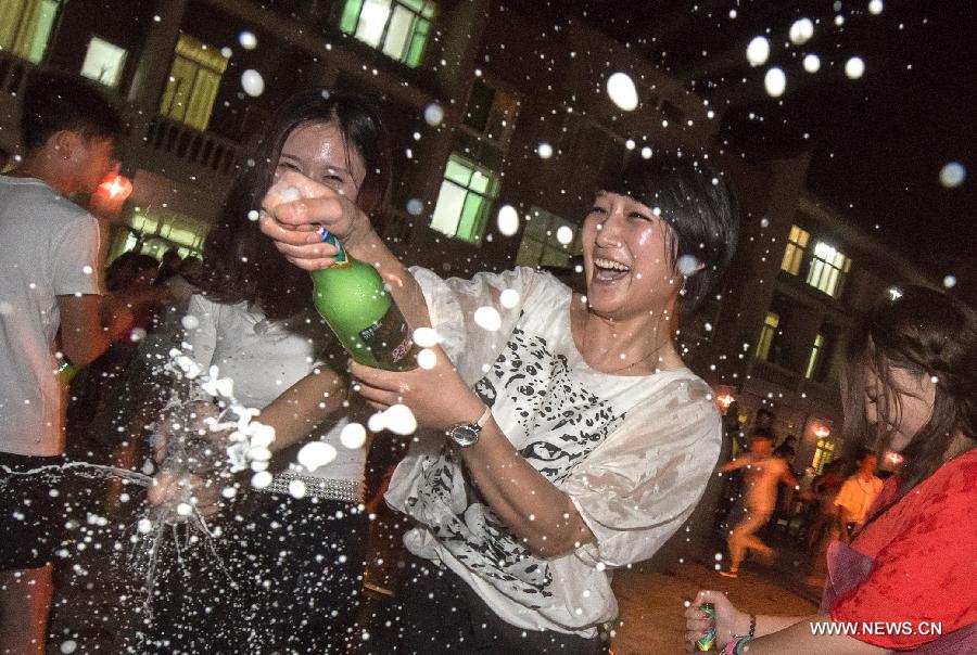 Tourists take part in a campfire party at Guifeng Mountain in Macheng City, central China's Hubei Province, July 27, 2013. A lot of citizens chose to escape the heat in the mountains due to the continuous scorching weather in Hubei province in recent days. (Xinhua/Cheng Min)  