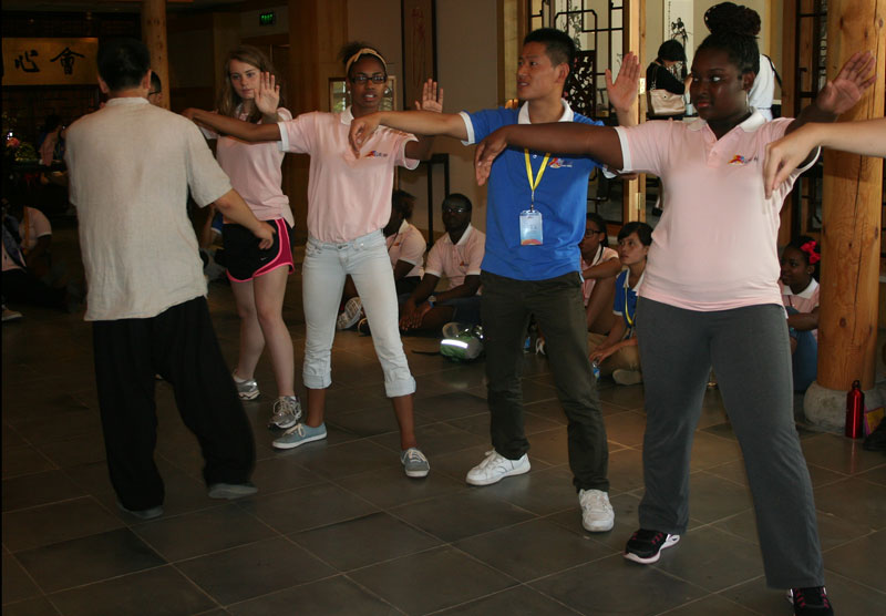 US girls and a Chinese boy learn the art of Taichi, one aspect of the "Rainbow Bridge" study camp, on Wednesday morning, July 24, 2013. [Photo: CRIENGLISH.com] 