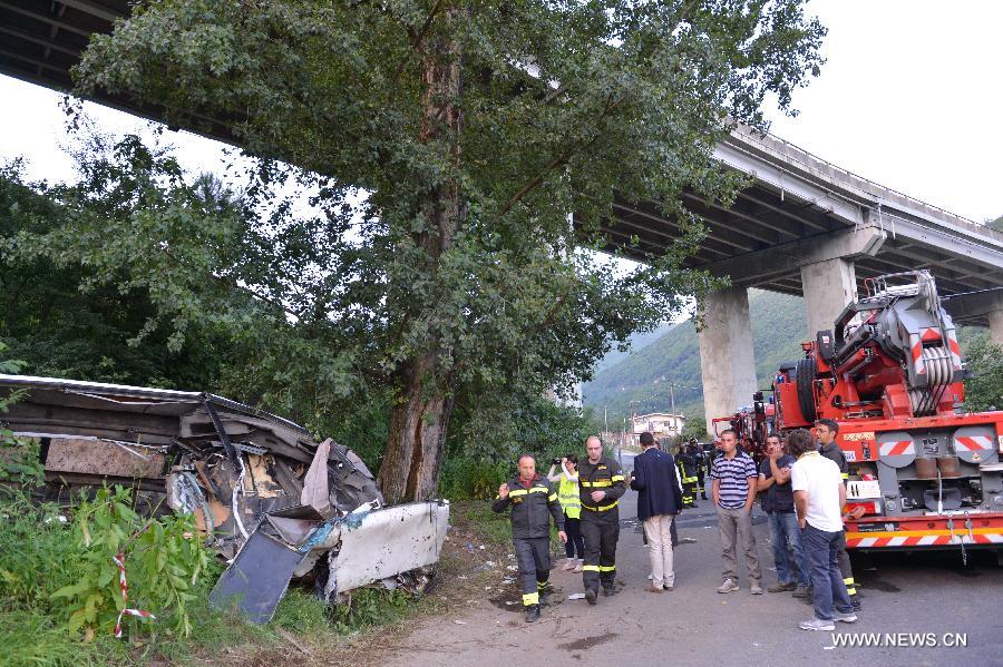 Firemen inspect the scene of the accident in Avellino, southern Italy, on July 29, 2013. A tourist bus crashed through a highway guardrail in southern Italy Sunday night, killing 38 people and putting at least 10 others in critical condition. (Xinhua/Xu Nizhi) 