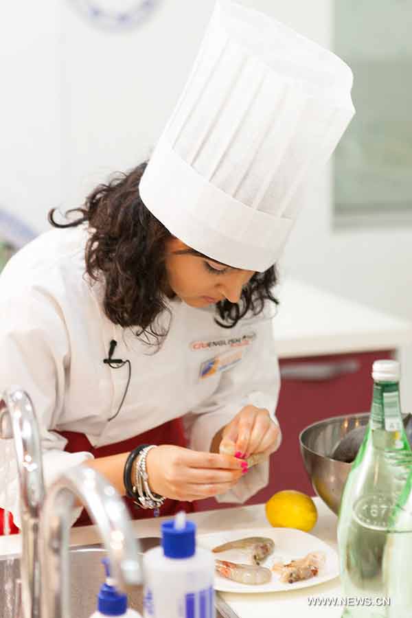 Giada Faggianno form Italy shells shrimps for her dish "Shrimps and Scallops sauteed in a dragon's nest of noodles" at "Chopsticks and Beyond" Cantonese Cuisine Competition in Beijing, June 27, 2013. "Chopsticks and Beyond" is a Chinese cuisine challenge launched by CRIENGLISH.com to provide a platform for foreign food enthusiasts to show off their Chinese cooking skills and explore creative dishes with exotic flavor. It features China's four great traditions: Sichuan Cuisine, Cantonese Cuisine, Shandong Cuisine and Huaiyang Cuisine. (Xinhuanet/Yang Yi)