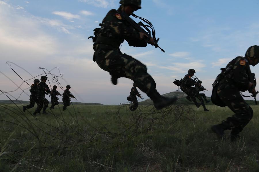 Female soldiers receive training at the Zhurihe training base in north China's Inner Mongolia Autonomous Region, July 17, 2013. The first female special forces unit established by the Chinese People's Liberation Army received intensive training as the Army Day is coming. The youngest soldier of the unit is 18 years old while the oldest one is 26. All of the female soldiers have college degrees or above and have been trained to master special combat skills. (Xinhua/Wang Jianmin)