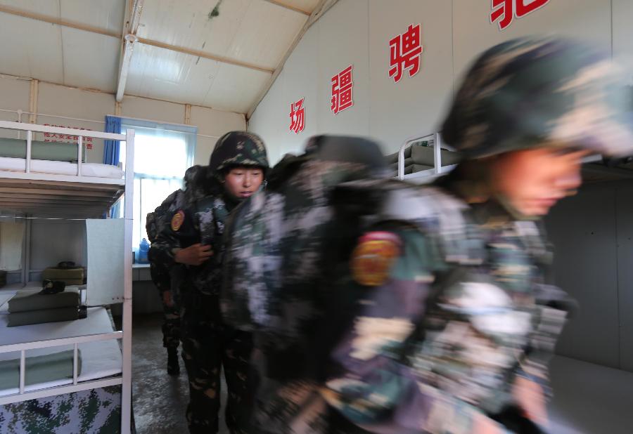 Female soldiers respond to an emergency call at the Zhurihe training base in north China's Inner Mongolia Autonomous Region, July 16, 2013. The first female special forces unit established by the Chinese People's Liberation Army received intensive training as the Army Day is coming. The youngest soldier of the unit is 18 years old while the oldest one is 26. All of the female soldiers have college degrees or above and have been trained to master special combat skills. (Xinhua/Wang Jianmin)