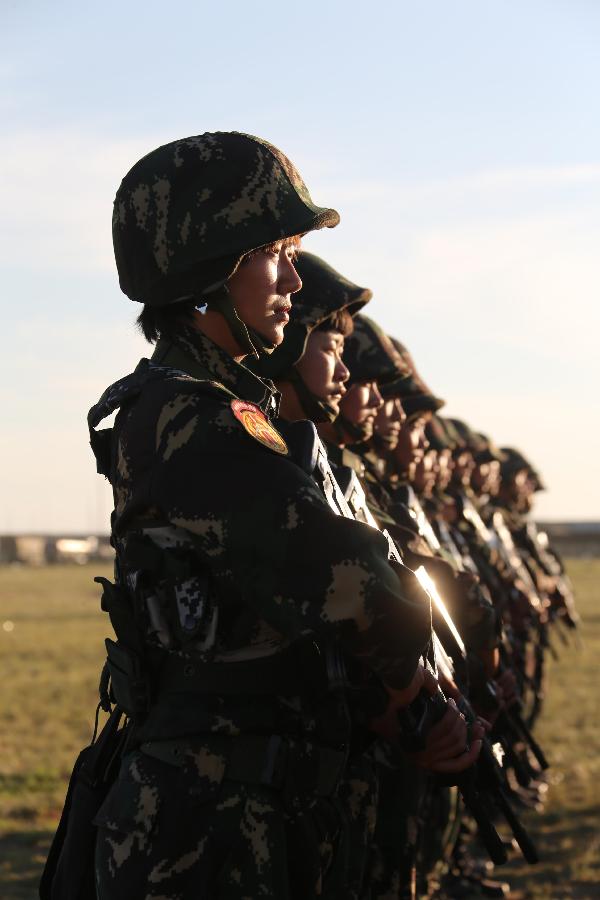 Female soldiers wait for tasks at the Zhurihe training base in north China's Inner Mongolia Autonomous Region, July 16, 2013. The first female special forces unit established by the Chinese People's Liberation Army received intensive training as the Army Day is coming. The youngest soldier of the unit is 18 years old while the oldest one is 26. All of the female soldiers have college degrees or above and have been trained to master special combat skills. (Xinhua/Wang Jianmin)