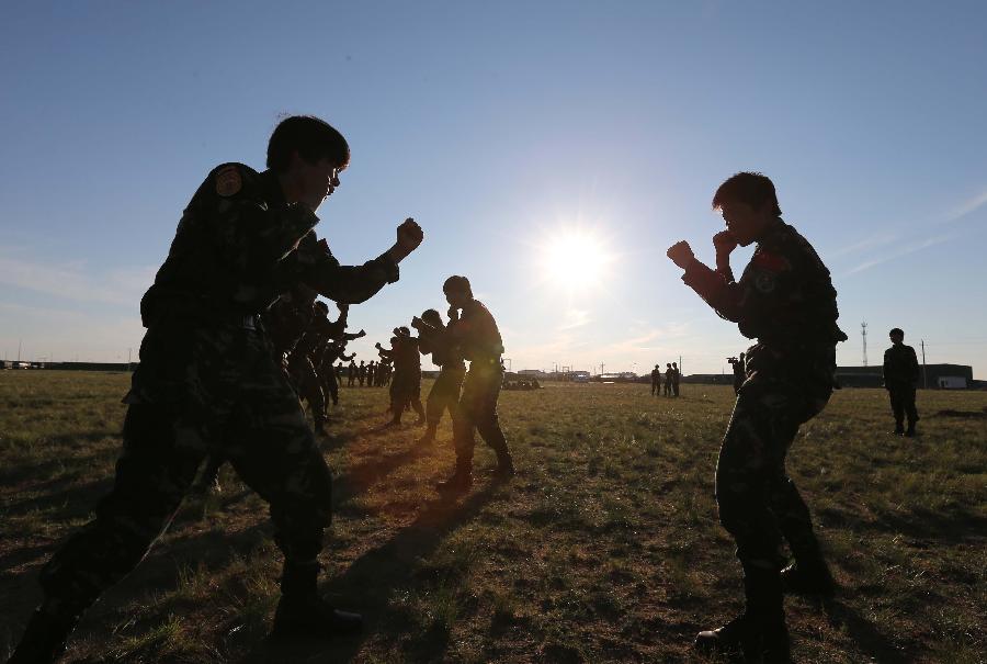 Female soldiers practice hand-to-hand combat at the Zhurihe training base in north China's Inner Mongolia Autonomous Region, July 16, 2013. The first female special forces unit established by the Chinese People's Liberation Army received intensive training as the Army Day is coming. The youngest soldier of the unit is 18 years old while the oldest one is 26. All of the female soldiers have college degrees or above and have been trained to master special combat skills. (Xinhua/Wang Jianmin)