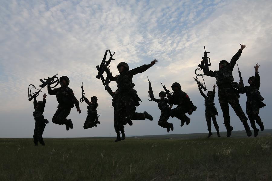 Female soldiers finish shooting training at the Zhurihe training base in north China's Inner Mongolia Autonomous Region, July 17, 2013. The first female special forces unit established by the Chinese People's Liberation Army received intensive training as the Army Day is coming. The youngest soldier of the unit is 18 years old while the oldest one is 26. All of the female soldiers have college degrees or above and have been trained to master special combat skills. (Xinhua/Wang Jianmin)