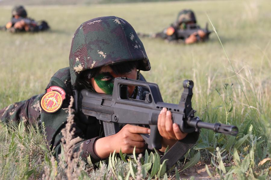 Female soldiers receive tactical trainings at the Zhurihe training base in north China's Inner Mongolia Autonomous Region, July 17, 2013. The first female special forces unit established by the Chinese People's Liberation Army received intensive training as the Army Day is coming. The youngest soldier of the unit is 18 years old while the oldest one is 26. All of the female soldiers have college degrees or above and have been trained to master special combat skills. (Xinhua/Wang Jianmin)