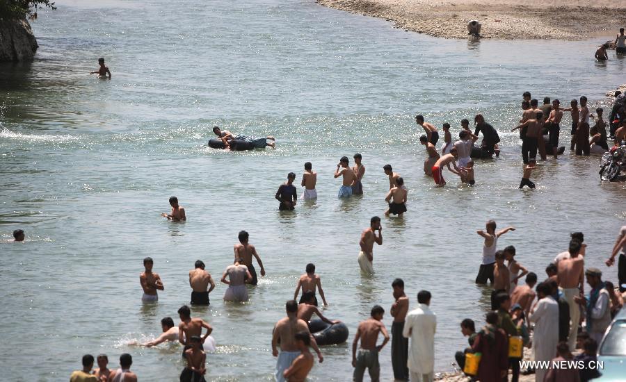 Afghans cool themselves in a canal in Parwan province of Afghanistan on July 29, 2013. (Xinhua/Ahmad Massoud) 