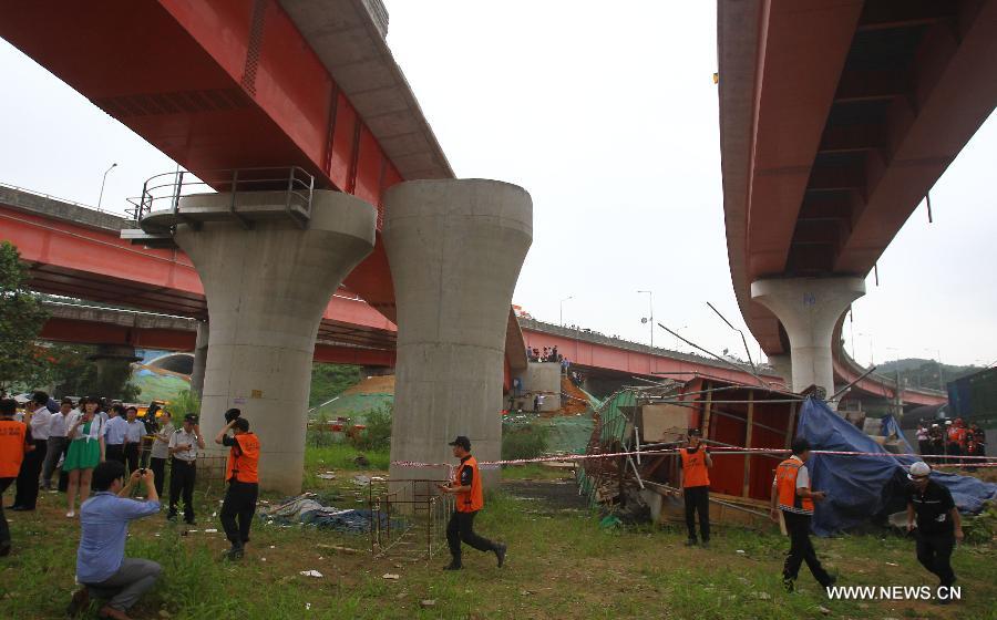 Rescuers work at the collapse site near the Banghwa Bridge in Seoul, South Korea, on July 30, 2013. Two Chinese workers were killed as a section of an under-construction ramp onto Banghwa Bridge collapsed Tuesday, according to Yonhap. (Xinhua/Yao Qilin) 