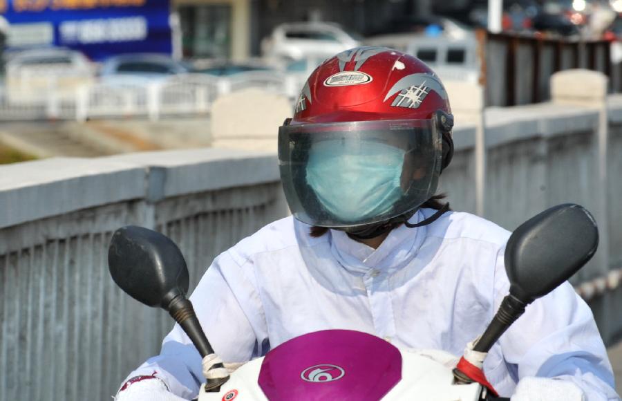 A citizen rides an electromobile in the burning sun in Changsha, capital of central China's Hunan Province, July 30, 2013. High temperatures sustained in the past month in Changsha and will continue in the coming 4 days. (Xinhua/Long Hongtao)