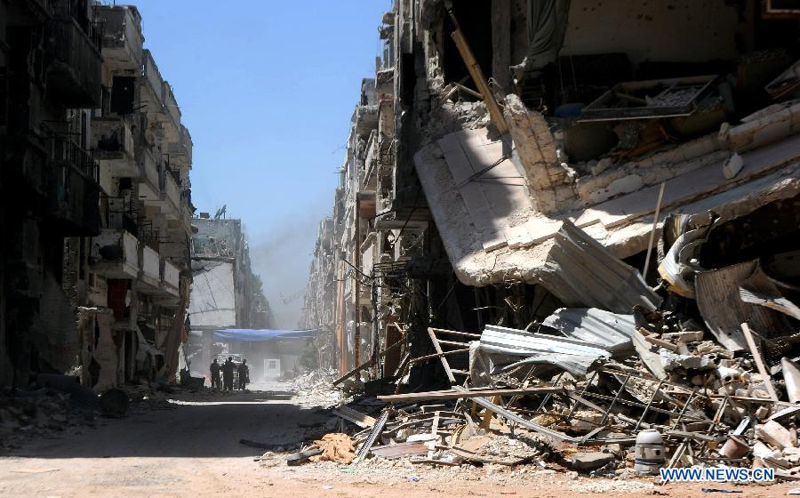 Soldiers of the Syrian army patrol in the street of al-Khalidieh district in central Homs province, Syria, July 30, 2013. The Syrian army announced Monday that its troops successfully regained full control over the strategic al-Khalidieh district in central Homs province after a series of precise operations there, according to the state-TV. (Xinhua/Zhang Naijie)