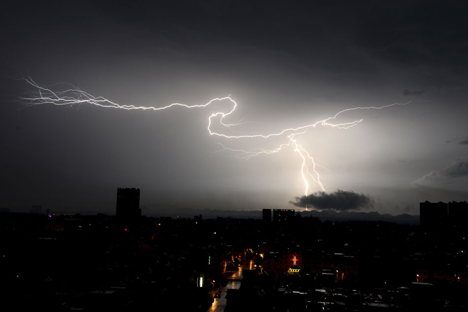 A lightening splits the dark sky in Luoping County, Yunnan, southwest of China. (Xinhua/Mao Hong)