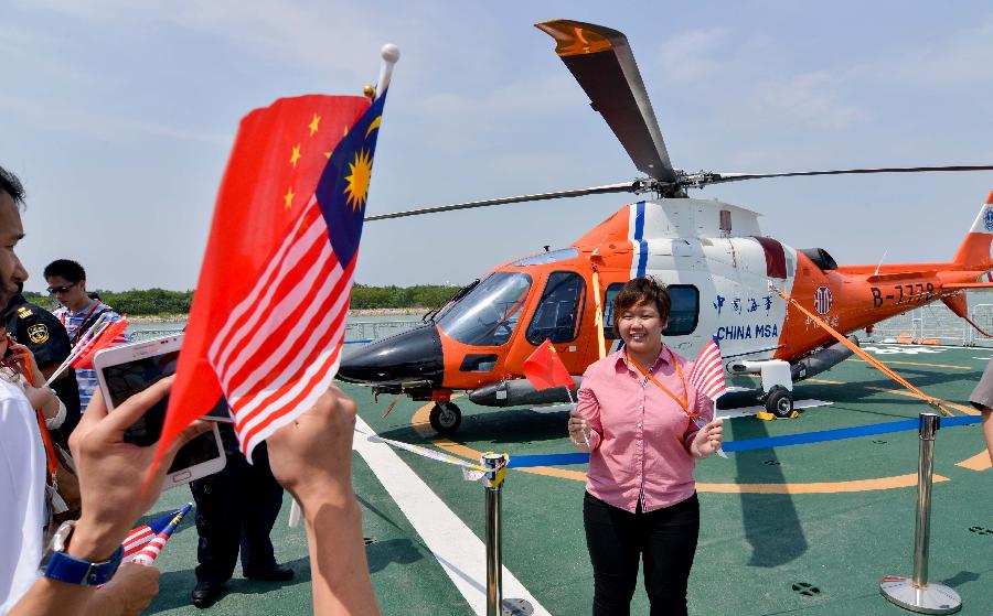 People take photos on the deck of Chinese patrol and search-and-rescue vessel "Haixun 01" in Pelaboham Kelang in Malaysia, July 31, 2013. The "Haixun 01" arrived in Pelaboham Kelang Wednesday for a five-day visit. (Xinhua/Chong Voon Chung)