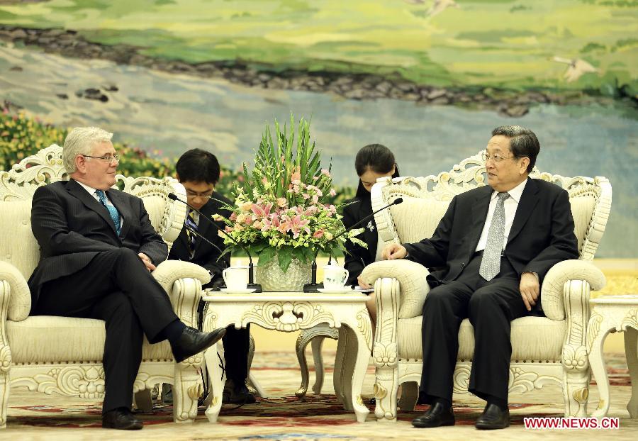 Yu Zhengsheng (R), chairman of the National Committee of the Chinese People's Political Consultative Conference, meets with Irish Deputy Prime Minister and Minister for Foreign Affairs and Trade Eamon Gilmore in Beijing, capital of China, July 31, 2013. (Xinhua/Ding Lin)