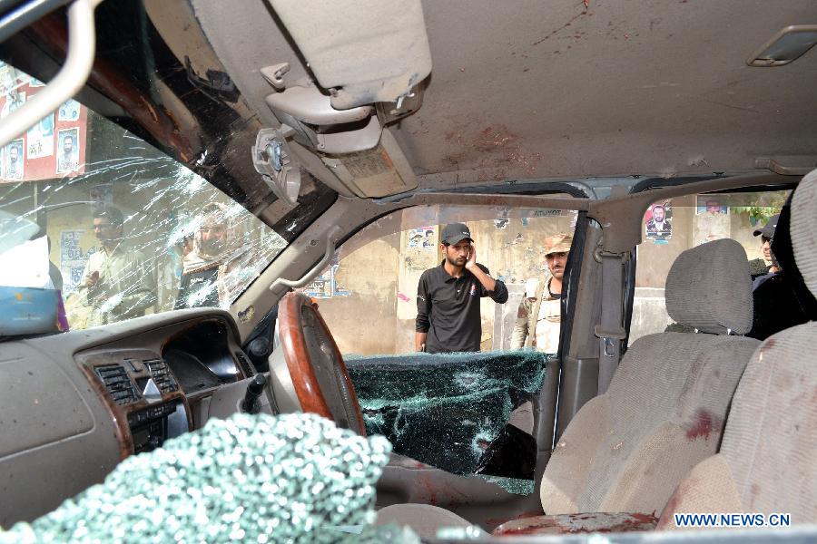 Policemen inspect a damaged vehicle at firing site in southwest Pakistan's Quetta on July 31, 2013. At least three people were killed and five others injured as unknown gunmen opened fire on a vehicle at Prince Road in Quetta on Wednesday, local media reported. (Xinhua/Asad)