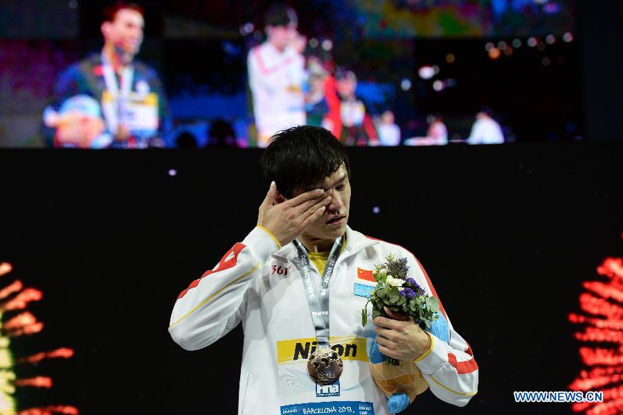 Sun Yang of China reacts during the awarding ceremony of the men's 800m freestyle final of the swimming competition at the 15th FINA World Championships in Barcelona, Spain on July 31, 2013. Sun Yang won the gold medal with 7 minutes and 41.36 seconds. (Xinhua/Guo Yong)