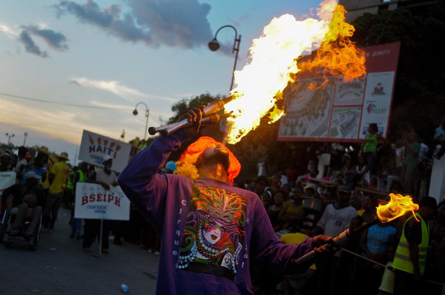 A Haitian reveler participates in the Carnival of the Flowers of Haiti, in Port au Prince downtown, capital of Haiti, on July 31, 2013. Carnival of the Flowers of Haiti second edition, which convened thousands of people, bands, floats and costumed groups, was closed on Wednesday in the Haitian capital. (Xinhua/Swoan Parker)