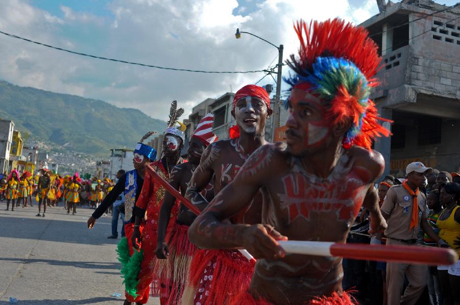 Members of a Haitian group participate in the Carnival of the Flowers of Haiti, in Port au Prince downtown, capital of Haiti, on July 31, 2013. Carnival of the Flowers of Haiti second edition, which convened thousands of people, bands, floats and costumed groups, was closed on Wednesday in the Haitian capital. (Xinhua/Swoan Parker)