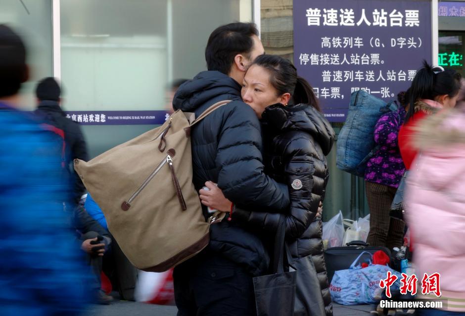 A couple hugs before separating from each other at the square of Beijing west railway station on Jan. 13, 2014. The annual Spring Festival travel rush is about to start. The Spring Festival, the most important occasion for a family reunion for the Chinese people, falls on the first day of the first month of the traditional Chinese lunar calendar, or Jan. 31 this year. (CNS/ Du Yang)
