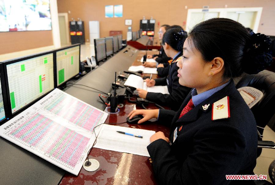 Staff members check the high-speed train schedule in a control room of Zhengzhou East Railway Station in Zhengzhou, capital of central China's Henan Province, Jan. 15, 2014. Measures have been taken at the railway stations across the country to make passengers have a smooth and safe trip during the upcoming 40-day Spring Festival travel rush. (Xinhua/Li An)
