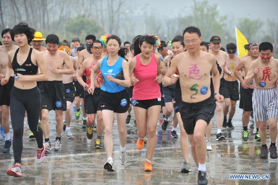 People wearing underwear take part in a running race in Nanjing, capital of east China's Jiangsu Province, March 29, 2014. A special race was held here on Saturday, in which participants wore only underwear so as to advocate the 2014 Earth Hour event and promote the concept of green lifestyle. (Xinhua/Shen Peng) 