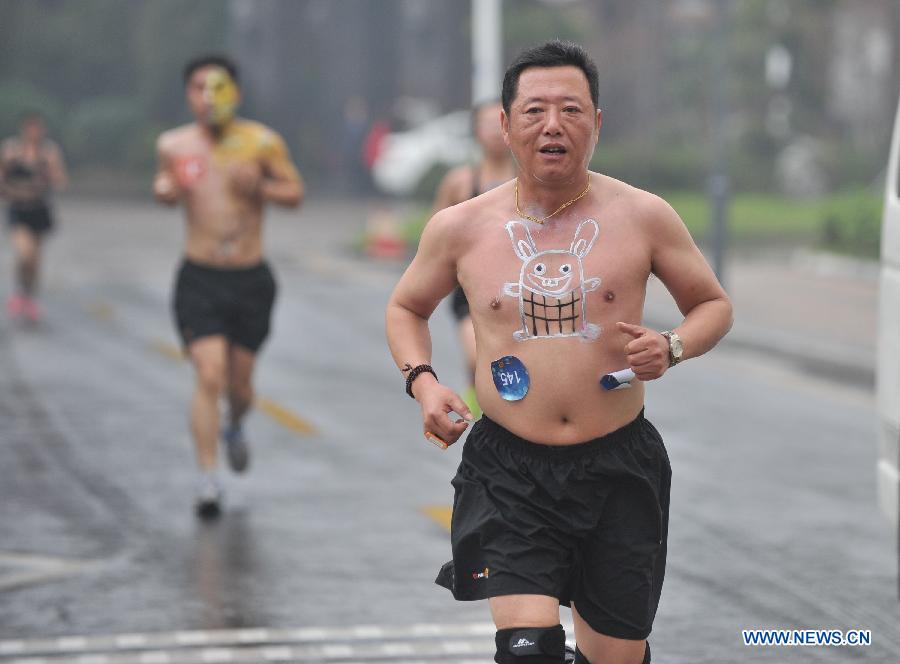 People wearing underwear take part in a running race in Nanjing, capital of east China's Jiangsu Province, March 29, 2014. A special race was held here on Saturday, in which participants wore only underwear so as to advocate the 2014 Earth Hour event and promote the concept of green lifestyle. (Xinhua/Shen Peng) 