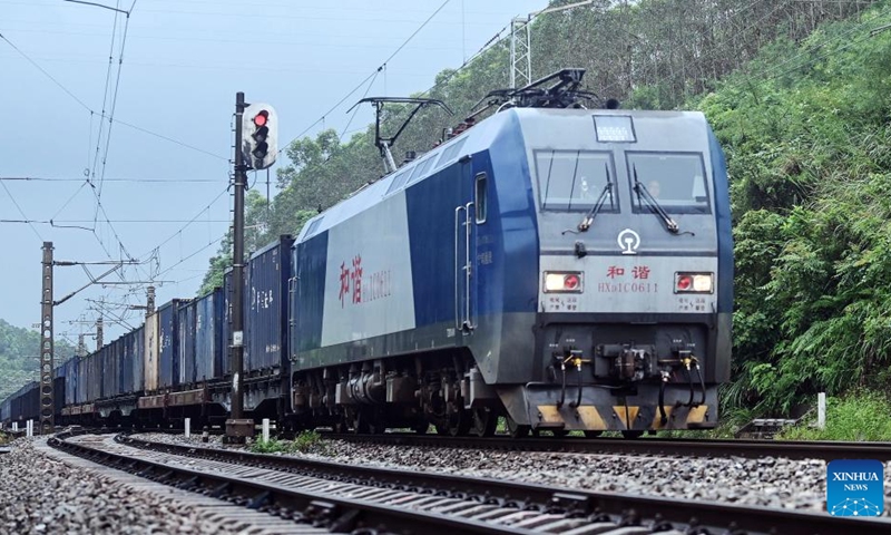 A train runs on the railway that constitutes part of the New International Land-Sea Trade Corridor on Aug. 2, 2024. As of Aug. 2 this year, more than 500,000 twenty-foot equivalent unit (TEU) containers for rail-sea intermodal transportation have been delivered via the New International Land-Sea Trade Corridor, the highest level for the same period in all years. The New International Land-Sea Trade Corridor, jointly built by provincial-level regions in western China and ASEAN members, expanded its reach to 490 ports across 120 countries and regions, according to data released in January by southwest China's Chongqing Municipality, the corridor's operational hub.  Photo: Xinhua