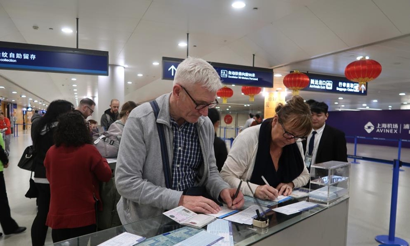 Foreign tourists fill out entry registration cards at the Shanghai Pudong International Airport in Shanghai, east China, Jan. 26, 2025. (Xinhua/Tang Siqi)