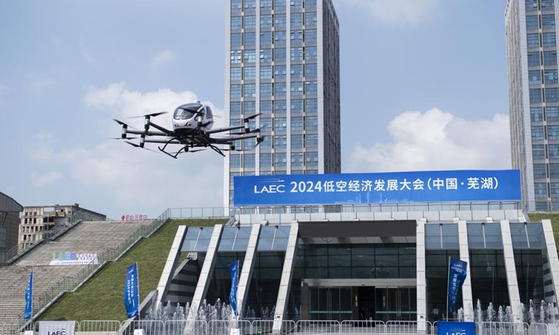 A low-altitude aircraft makes a flight demonstration outside the venue of the 2024 Low Altitude Economic Development Conference in Wuhu, east China's Anhui Province, Sept. 6, 2024. (Xinhua/Fu Tian)