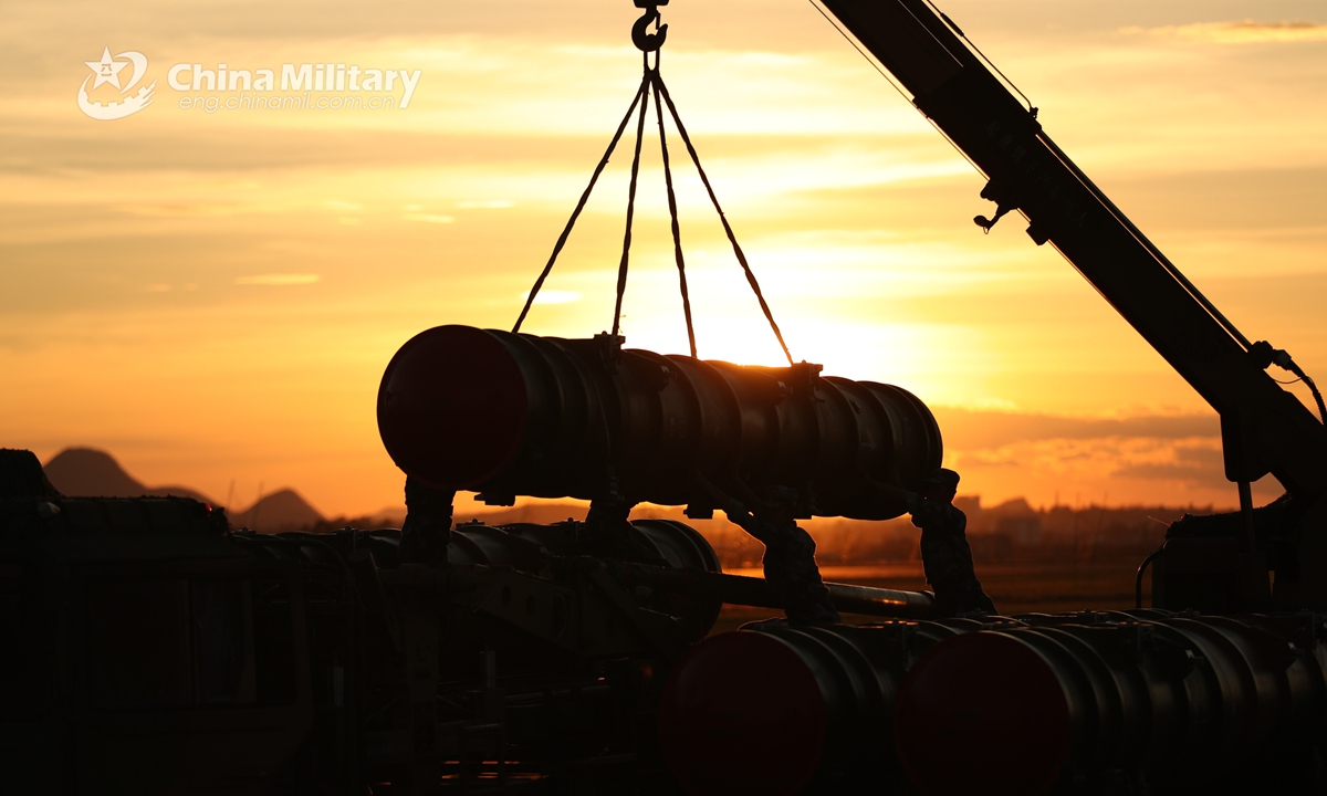 Soldiers assigned to a surface-to-air missile brigade of the air force under the PLA Southern Theater Command operate a crane to hoist and load an air-defense missile onto a launching platform during a recent maneuver. (eng.chinamil.com.cn/Photo by Yuan Hai and Xiang Kun)