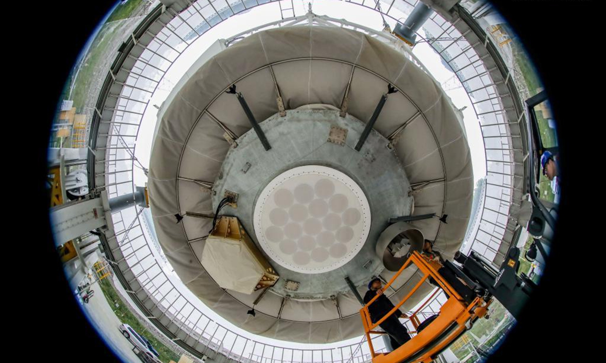 Photo taken with a fisheye lens on March 28, 2021 shows staff members conducting maintenance work on the feed cabin of the Five-hundred-meter Aperture Spherical Radio Telescope (FAST) in Pingtang County, southwest China's Guizhou Province. Starting formal operations in Jan. 11, 2020, the FAST is believed to be the largest and most sensitive radio telescope in the world, which has a huge potential for verifying and exploring mysteries of the universe. (Xinhua/Ou Dongqu)