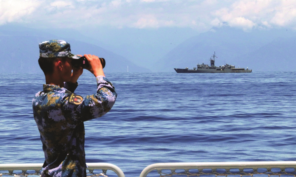 A soldier looks through binoculars during combat exercises and training of the navy of the Eastern Theater Command of the Chinese People's Liberation Army (PLA) in the waters around the Taiwan island, August 5, 2022. Photo: Xinhua