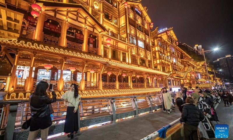 Tourists visit a commercial street in Yuzhong District in southwest China's Chongqing Municipality, Feb. 10, 2023. Chongqing has launched a variety of activities at nighttime to boost night economy since the beginning of this year.(Photo: Xinhua)