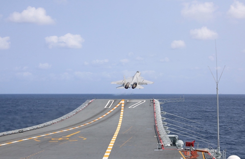 A J-15 fighter jet takes off from the aircraft carrier Shandong (Hull 17), which is a part of the combat alert patrols and 