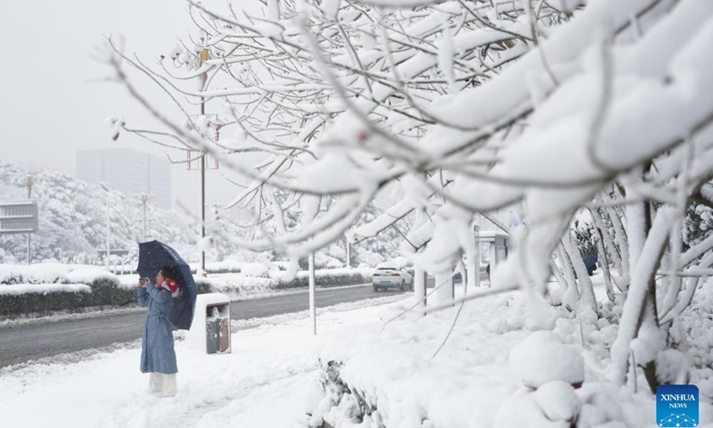 A woman takes photos of the snow scenery in Changsha, central China's Hunan Province, Jan. 22, 2024. Changsha saw its first snowfall of 2024 from Sunday night to Monday morning.(Photo: Xinhua)