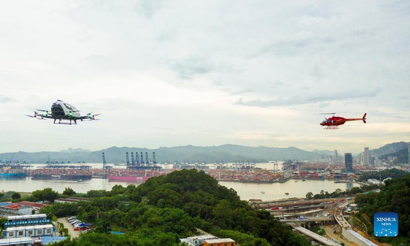 Aerial photo taken on Sept. 14, 2021 shows the demo flights of a Bell 206 helicopter (R) from HELI-EASTERN, a low-altitude general aviation carrier and helicopter service provider, and a passenger-grade autonomous aerial vehicle (AAV) from EHang, a leading AAV technology platform company, in an integrated airspace in Shenzhen, south China's Guangdong Province.(Photo: Xinhua)