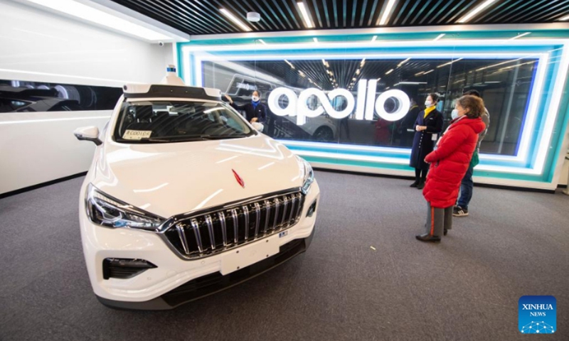 A staff member introduces an unmanned car at Apollo Park in Yangquan, north China's Shanxi Province, Feb. 25, 2022. (Xinhua/Yang Chenguang)